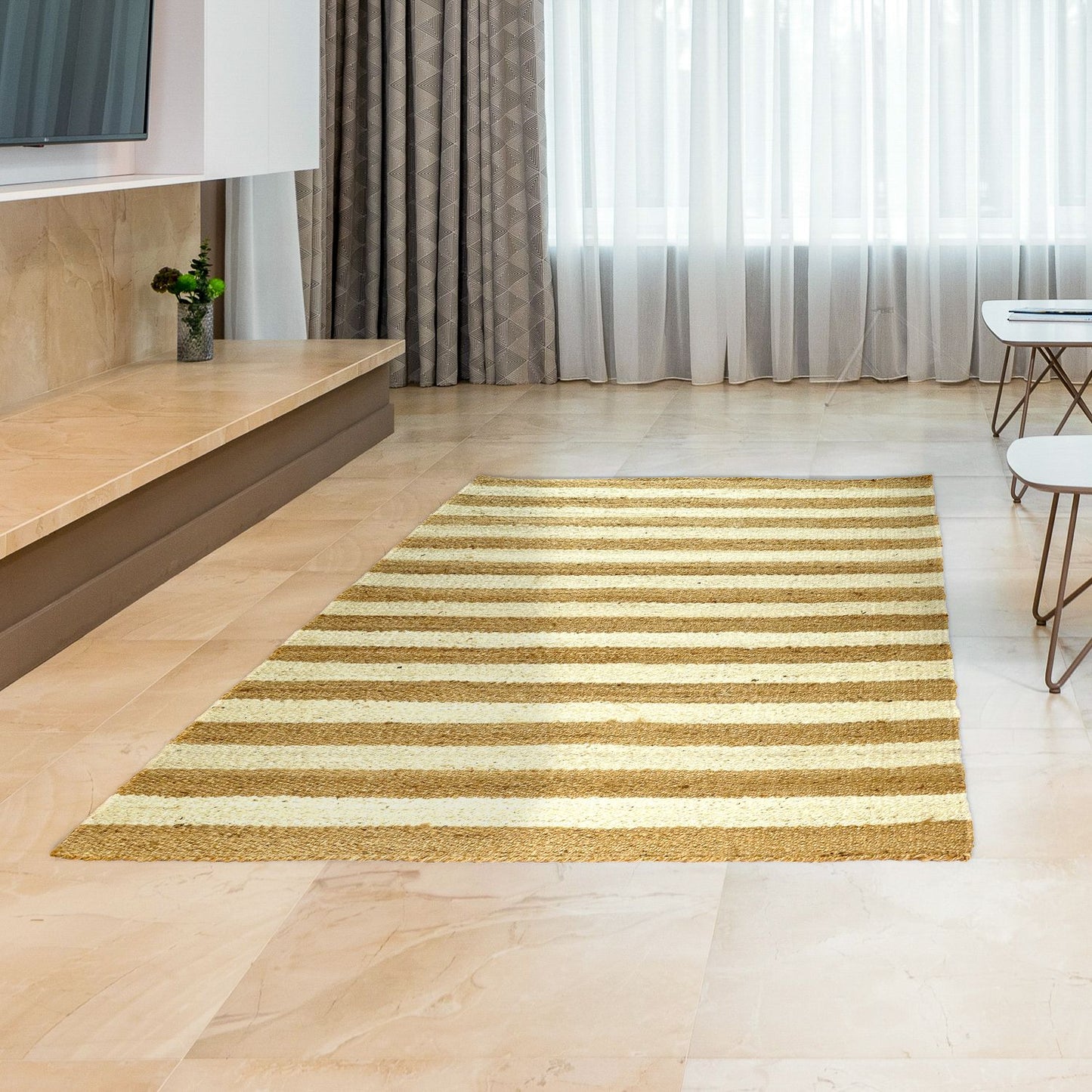 A rectangular, striped jute rug with a golden hue, placed on a light floor surface in a room with modern decor.