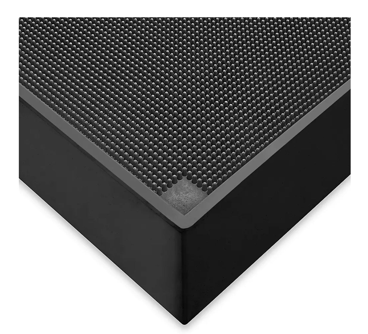 Black textured square block rubber floor mat on a white background