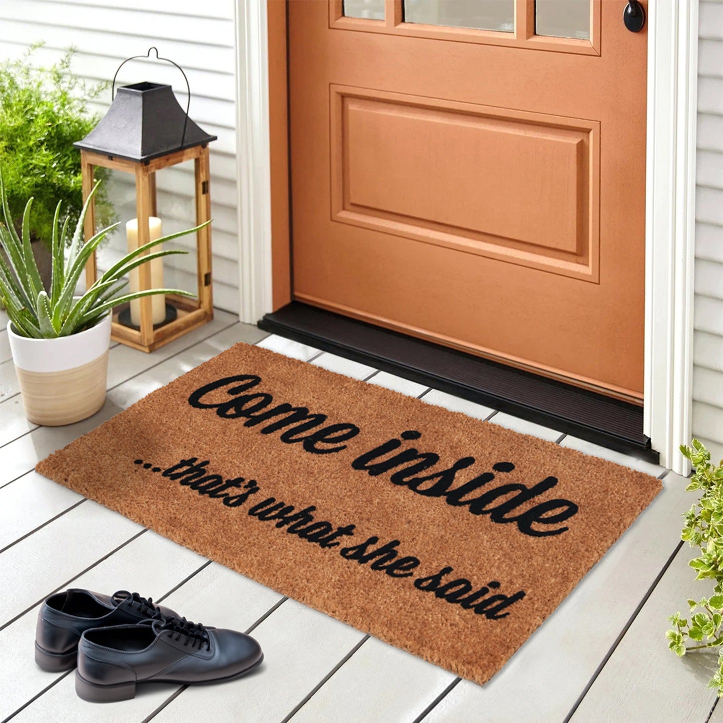 A rectangular natural coir door mat with a humorous text 'Come inside.