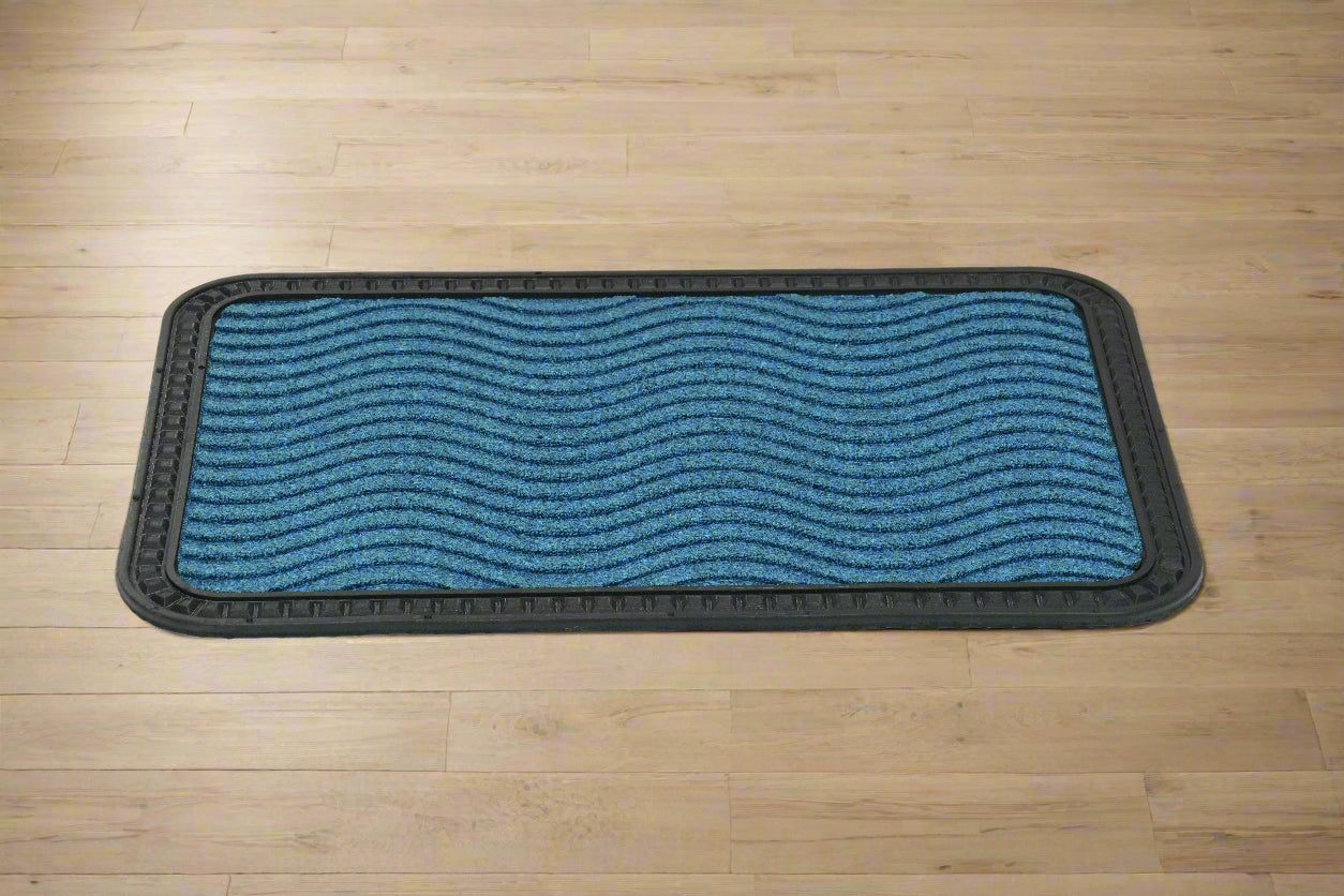A blue striped OnlyMat Quick Dry Anti Slip mat placed on a wooden floor.