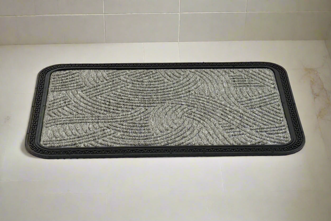 A grey rectangular Mat Quick Dry Anti Slip mat placed on a tiled floor, with a textured design and black edging.