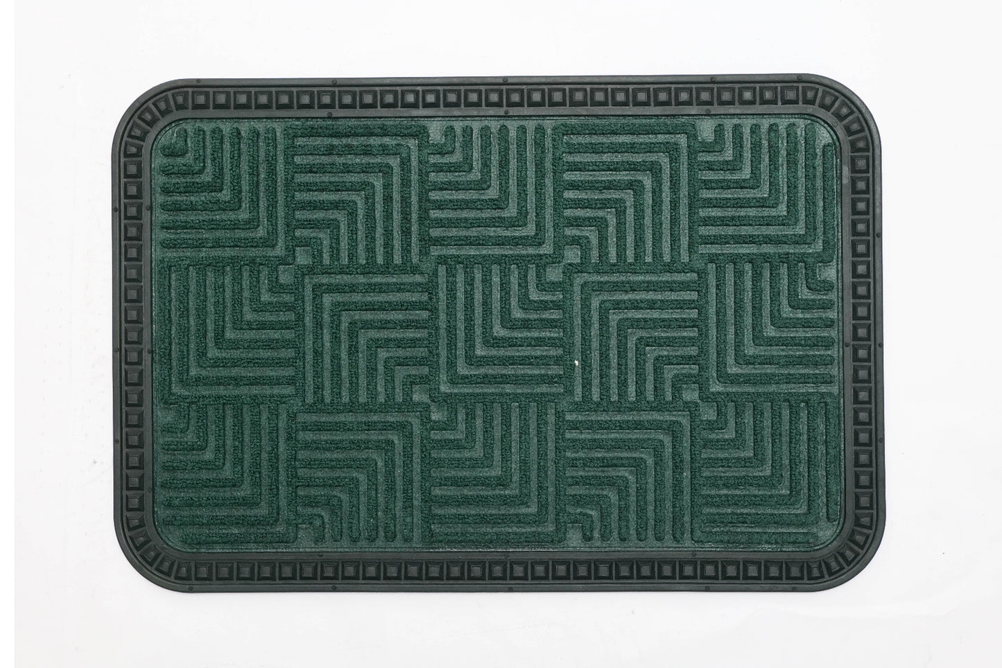 A green rectangular bath mat with a geometric step design pattern.