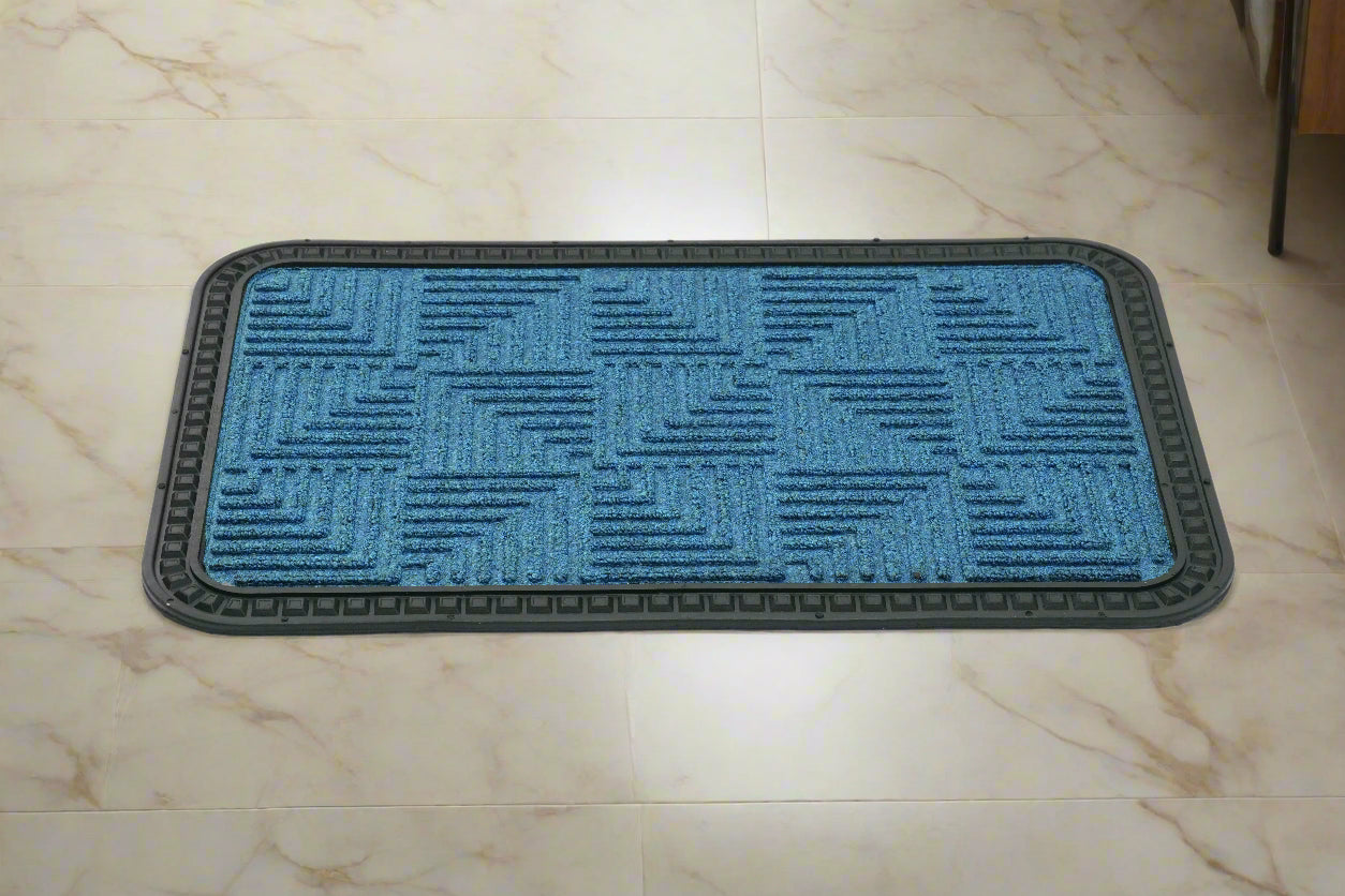 A blue rectangular OnlyMat with a geometric step design placed on a tiled floor.