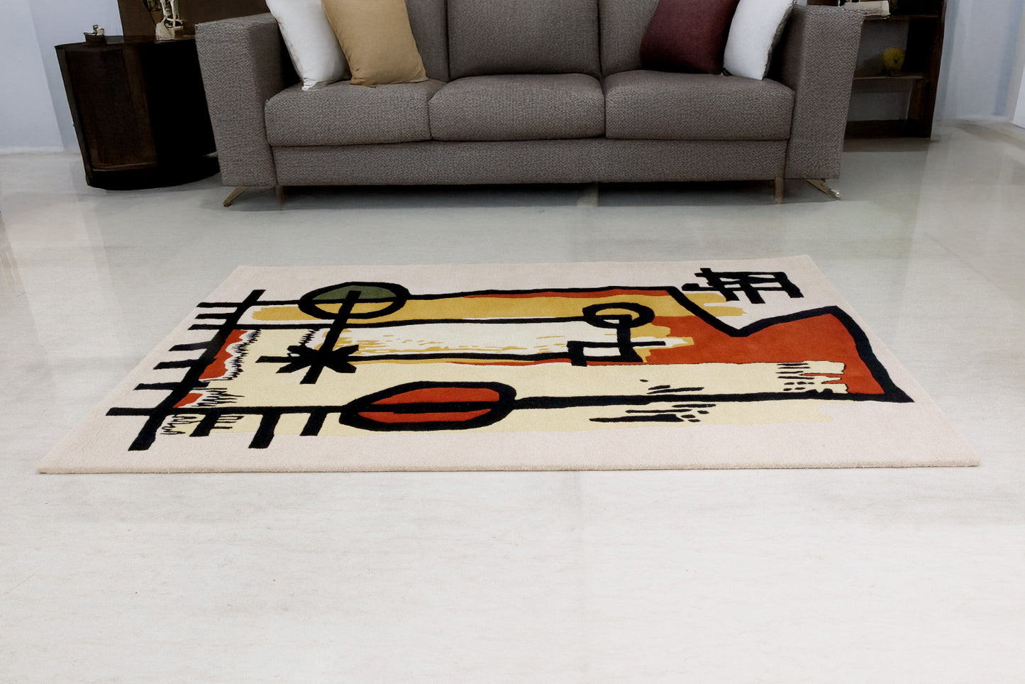 Abstract rug on a light-colored floor with a couch in the background
