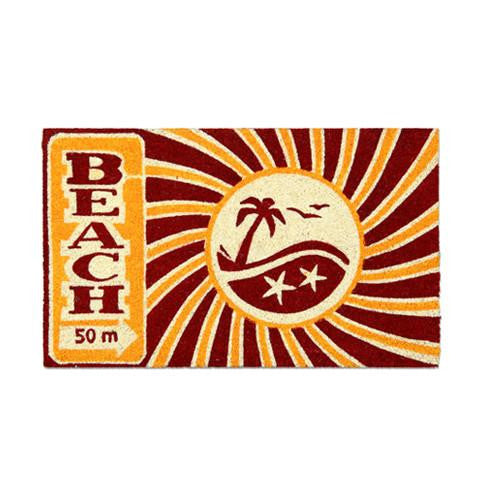 Rectangular natural coir floor mat with a printed design featuring the text 'BEACH' and a palm tree, indicating a beach-themed pattern.