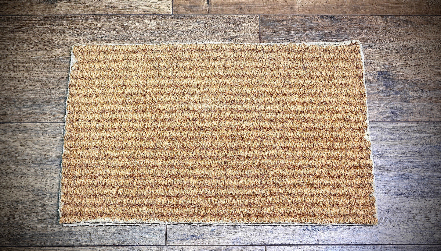 Beige coir doormat on a wooden floor