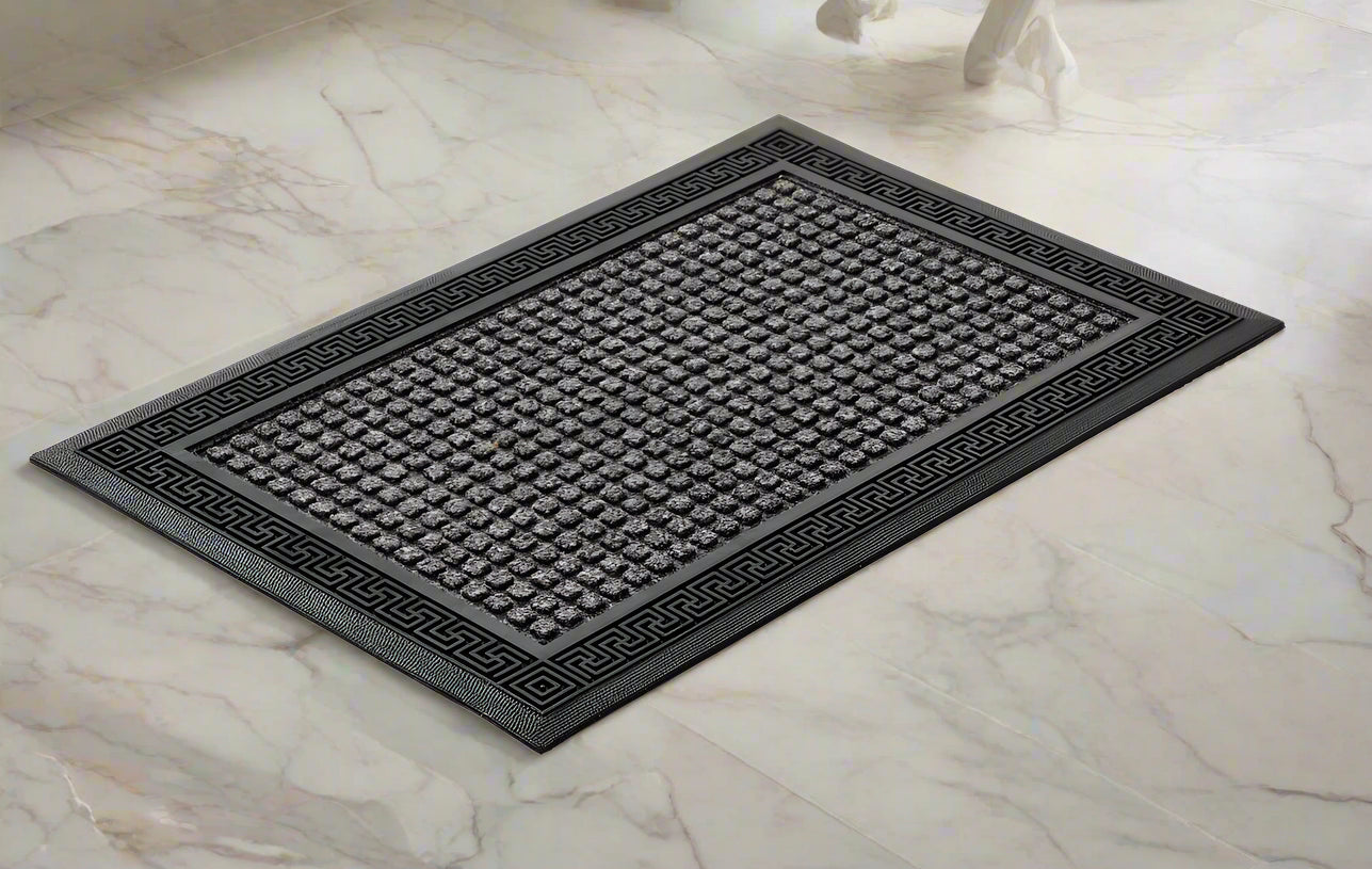 A grey, rectangular OnlyMat bath mat made of polypropylene with an anti-slip design, placed on a tiled floor.