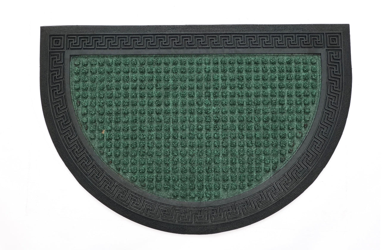 A green rectangular doormat with an intricate geometric pattern and a decorative border.