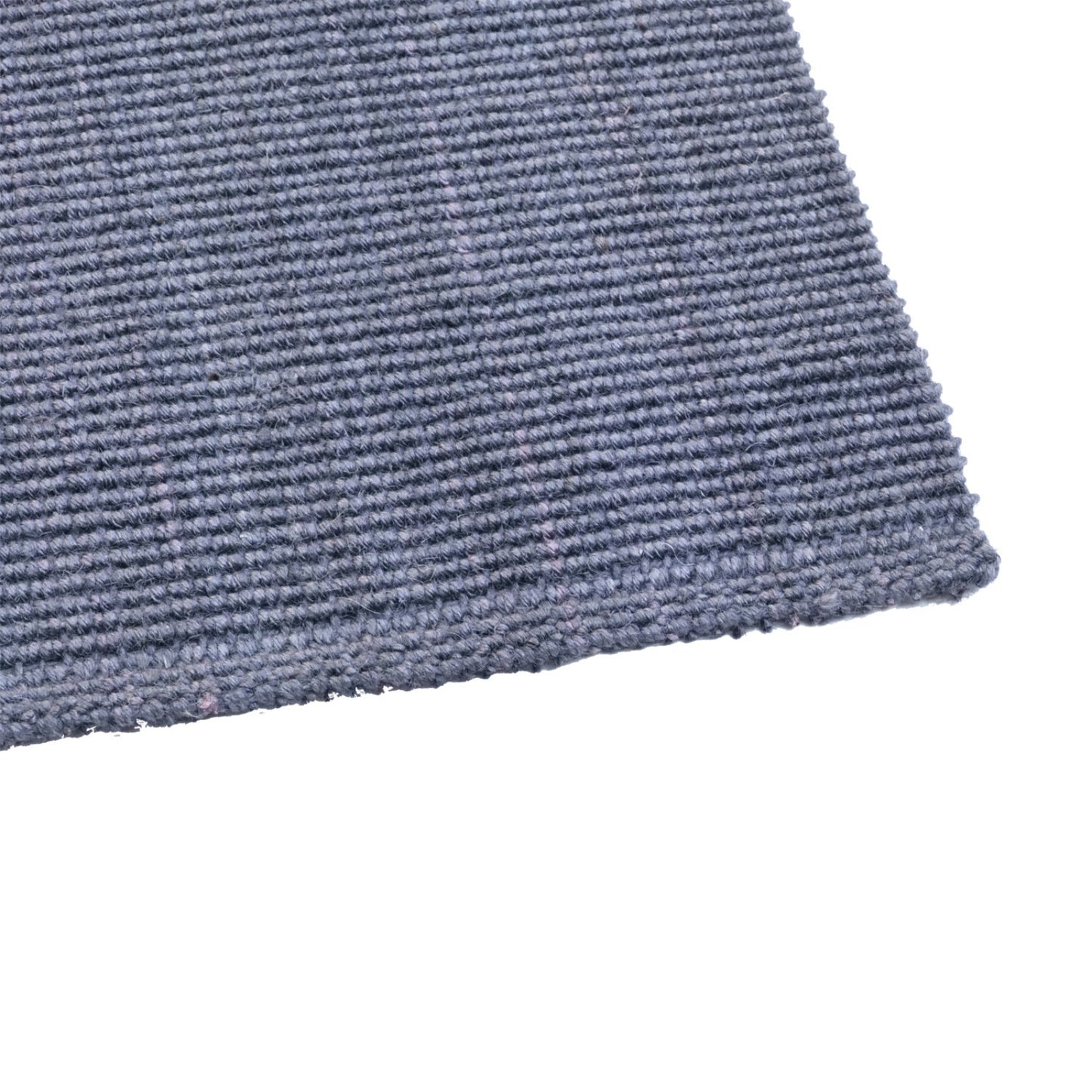 Close-up of a textured blue jute runner rug corner on a white background