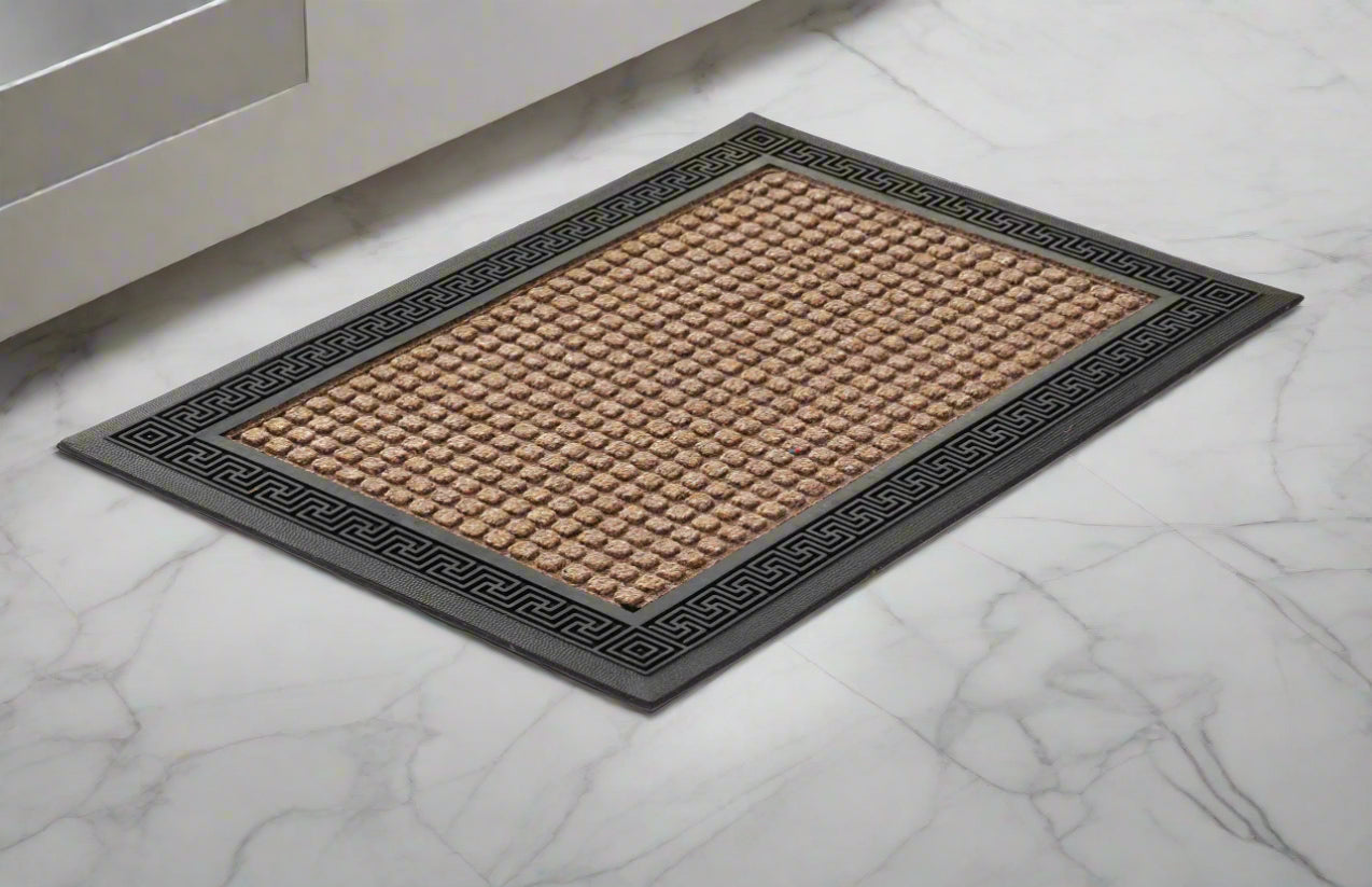 A beige polypropylene bathroom door mat with an anti-slip base, placed on a marble floor.