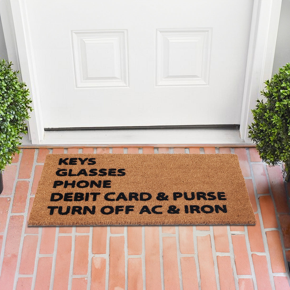 coir doormat features a printed checklist of commonly forgotten items – keys, glasses, phone, debit card & purse, and a reminder to turn off AC & iron