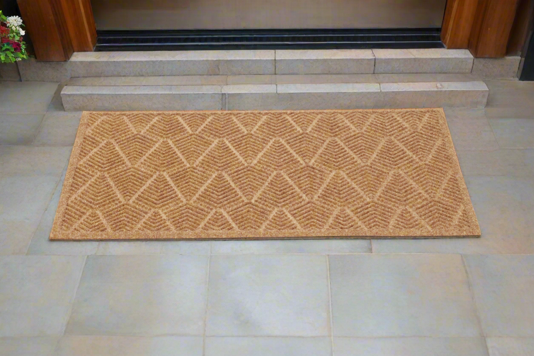 
                      
                        Patterned recycled PET doormat on a tiled floor in front of a door.
                      
                    
