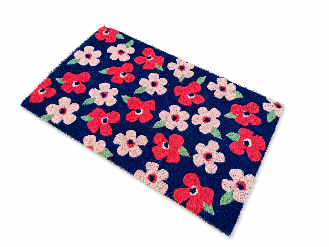 
                      
                        Floral patterned doormat with red and pink flowers on a blue background
                      
                    