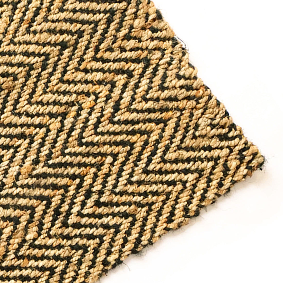 
                      
                        Close-up of a textured rug with a zigzag pattern on a white background
                      
                    