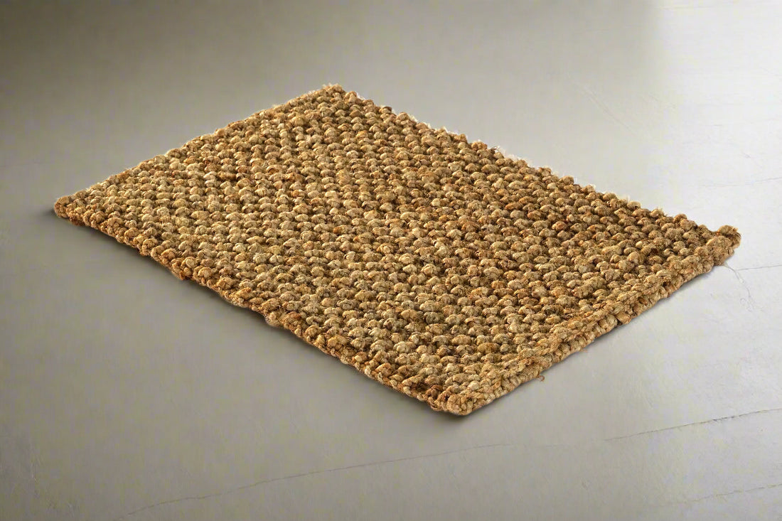 A rectangular, flatweave jute rug with a textured pile.