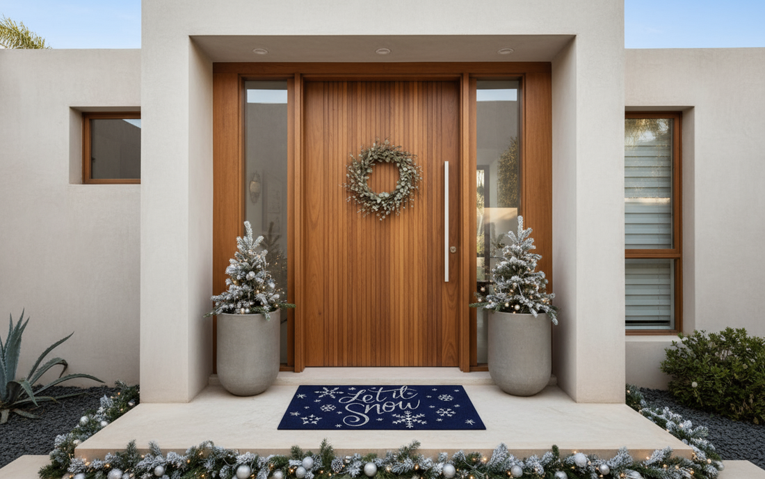 Modern house entrance with wooden door, wreath, and decorative coir mat.