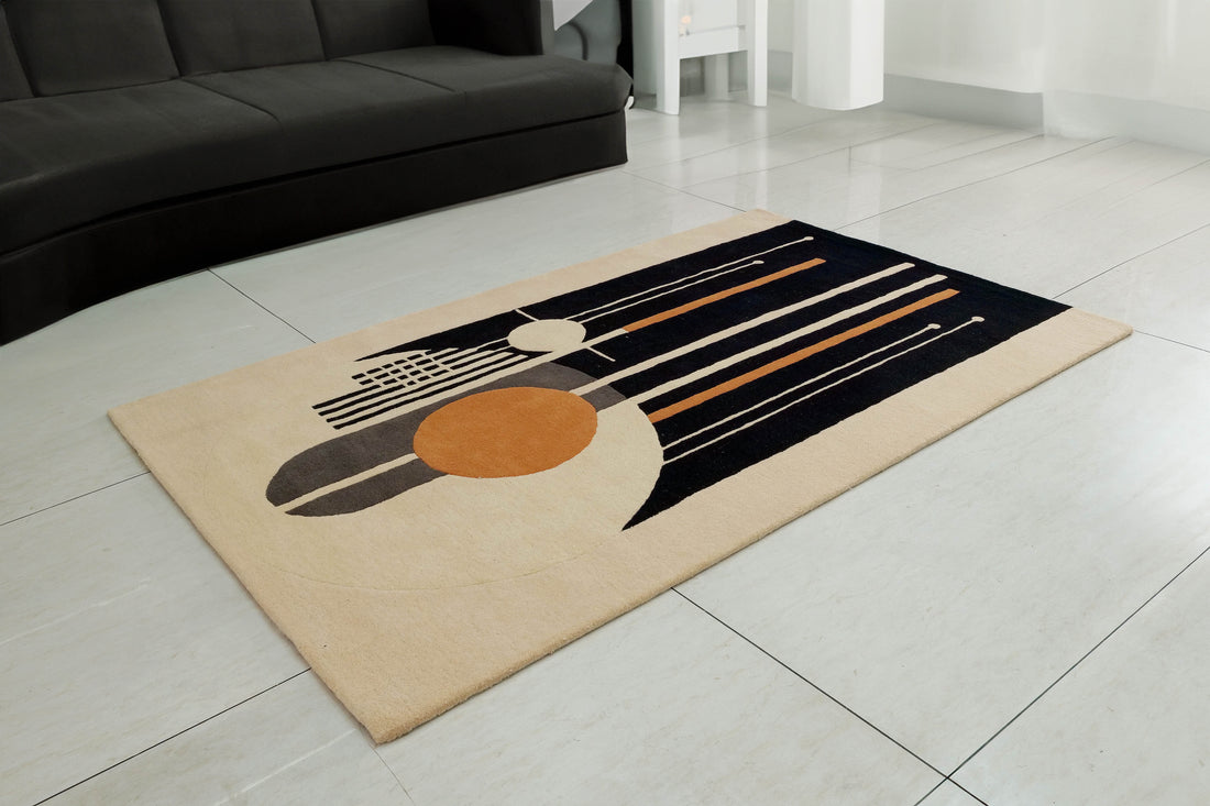 
                      
                        A beige and black hand-tufted Bamboo Silk rug with modern geometric patterns, placed on a tiled floor in a living room setting.
                      
                    