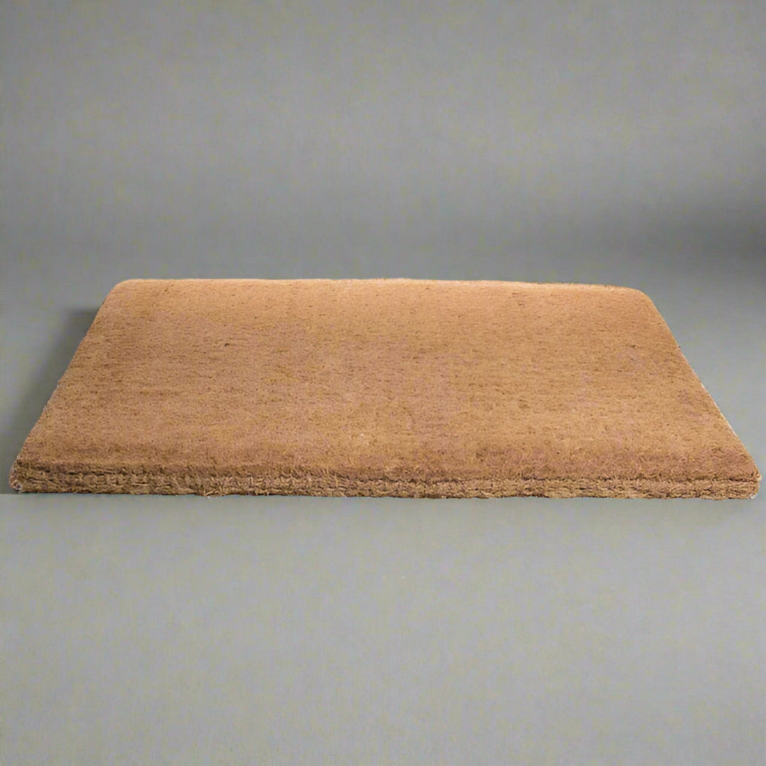 
                      
                        A plain brown rectangular traditional coir mat suitable for indoor or outdoor use.
                      
                    