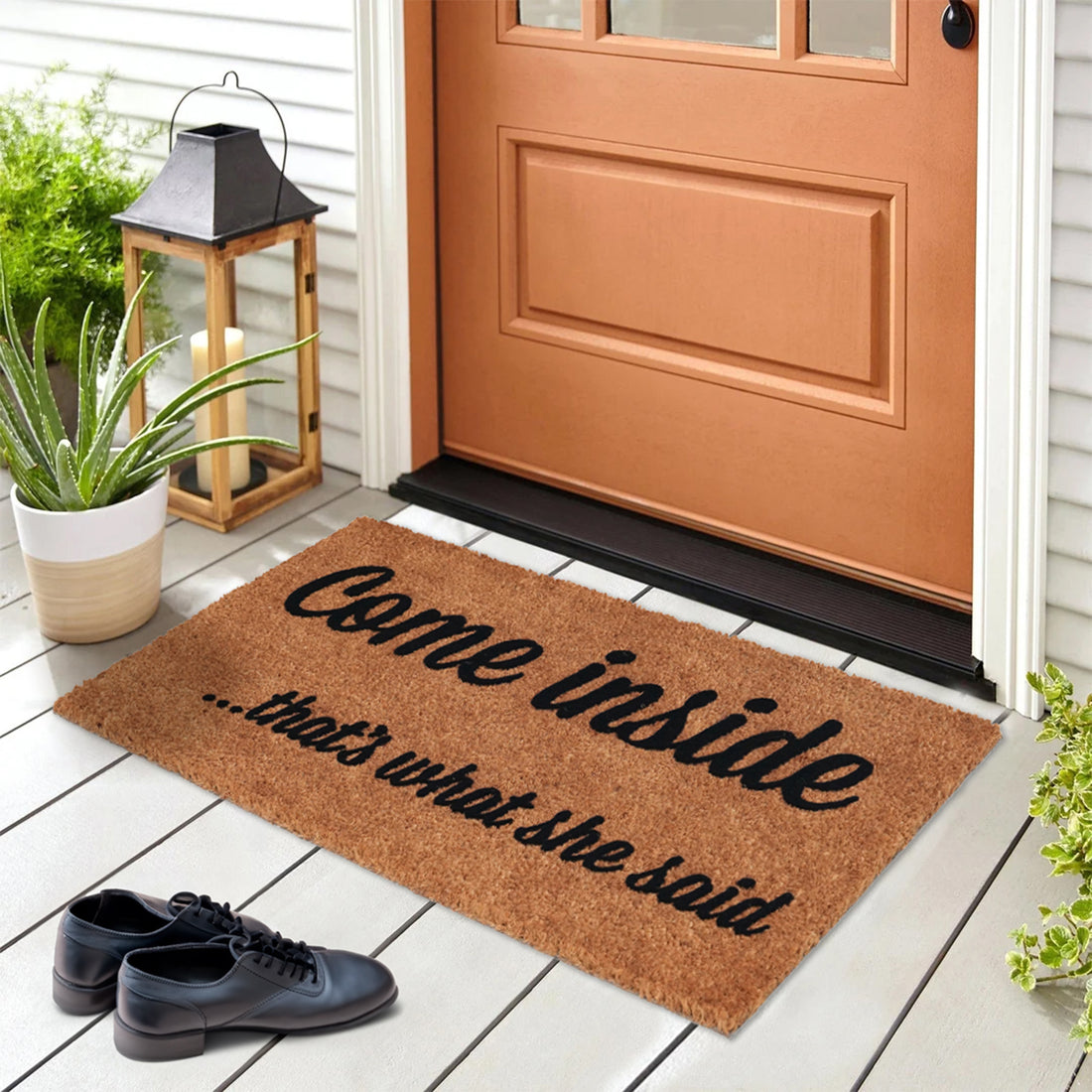 A rectangular natural coir door mat with a humorous text 'Come inside.