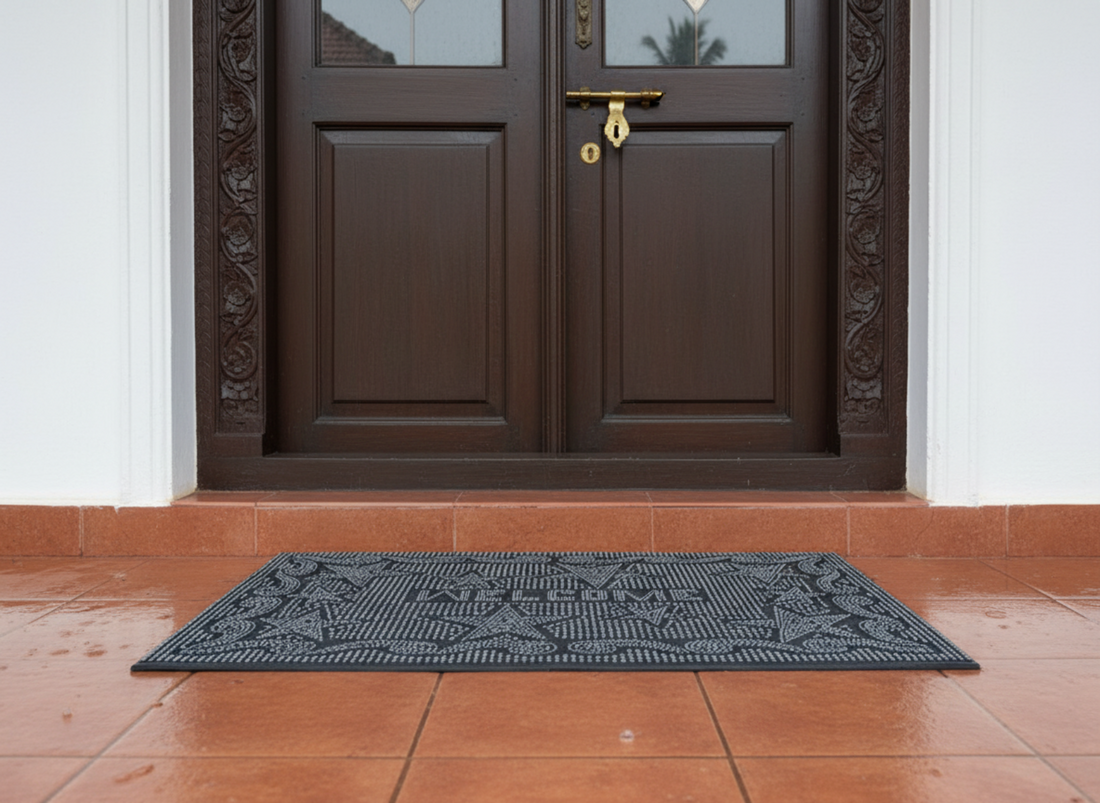 
                      
                        Black rubber pin doormat with a geometric pattern in front of a brown door
                      
                    