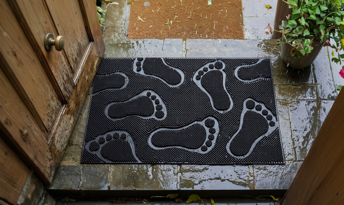 Doormat with footprints pattern on a wet doorstep