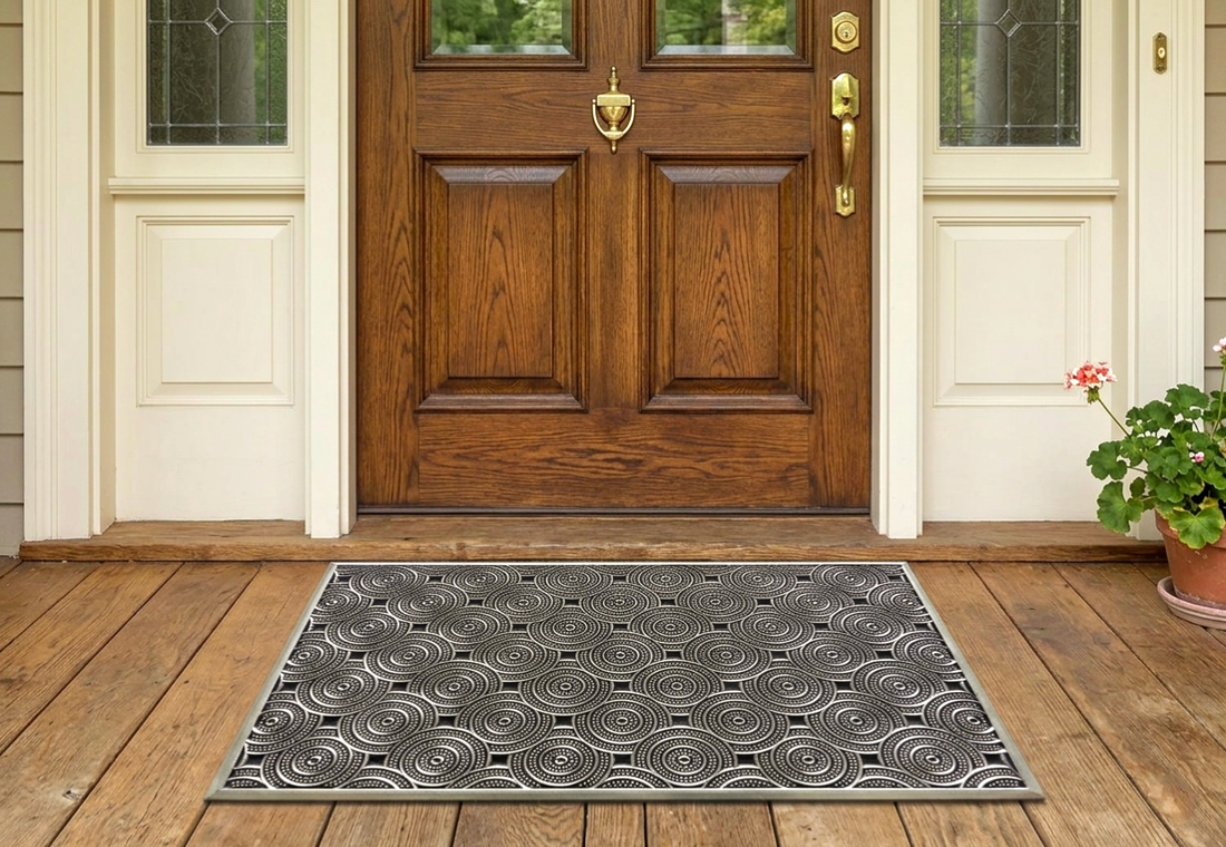 
                      
                        Patterned doormat in front of a wooden door on a wooden floor.
                      
                    
