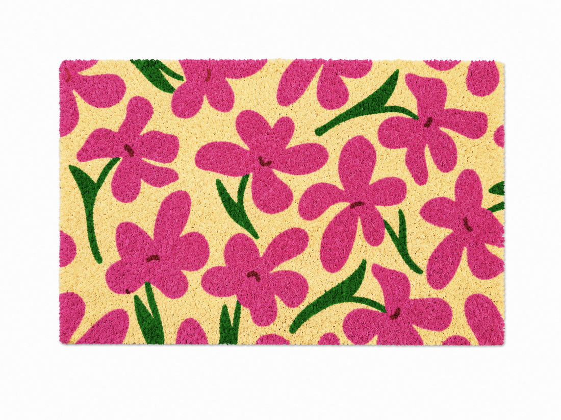 Floral patterned doormat with pink flowers on a beige background