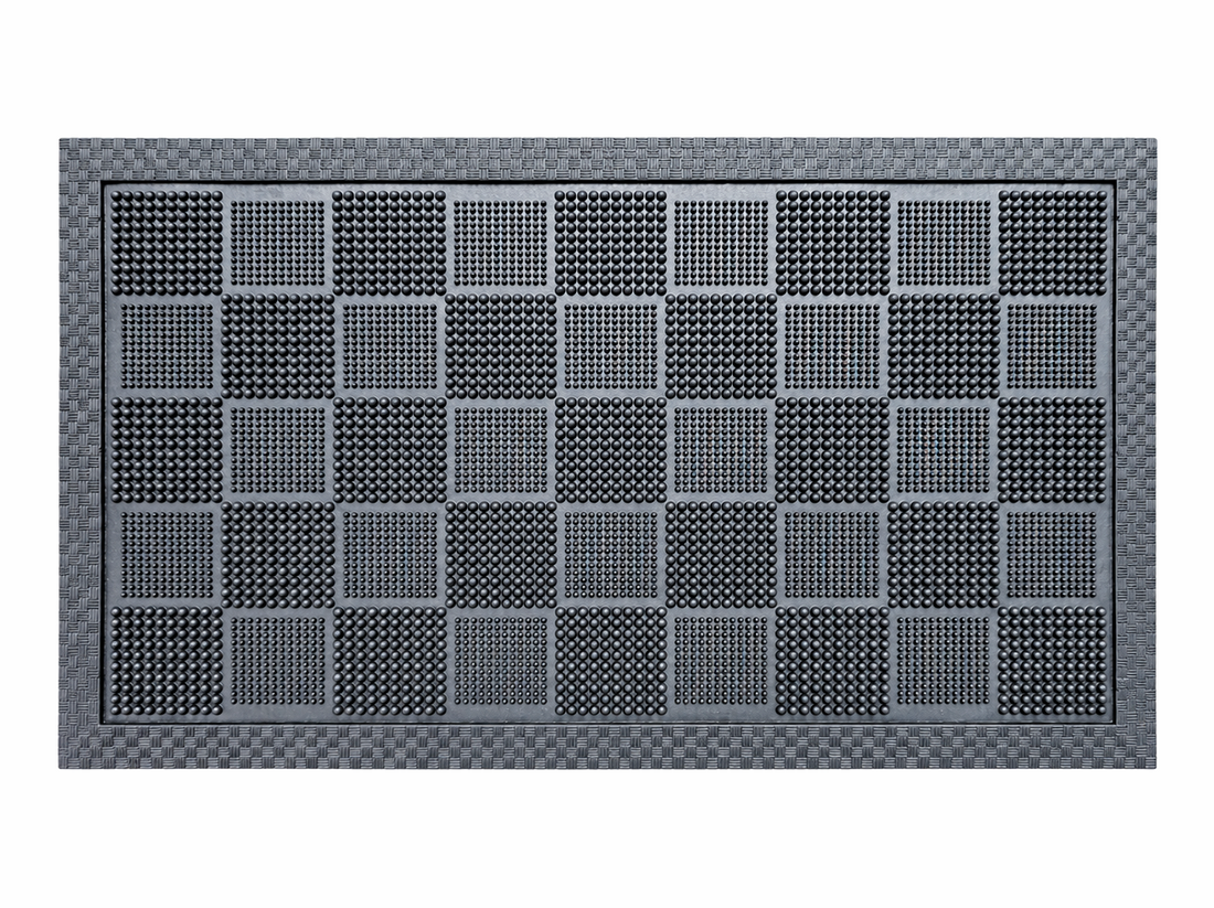 
                      
                        A rectangular black rubber mat with a textured carbon-fiber-look border and a grid of raised square panels, shown on a plain white background.
                      
                    