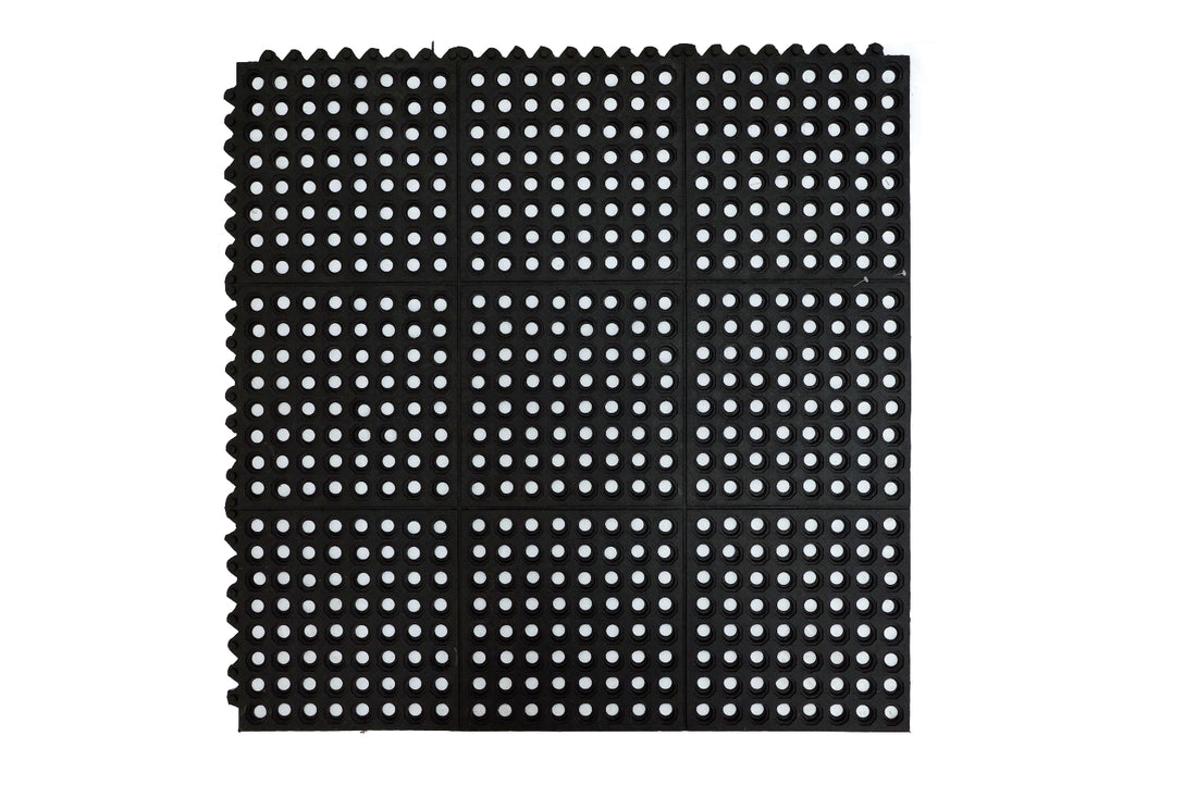 
                      
                        Interlocking black rubber mat with a hollow circular pattern designed for anti-fatigue flooring.
                      
                    