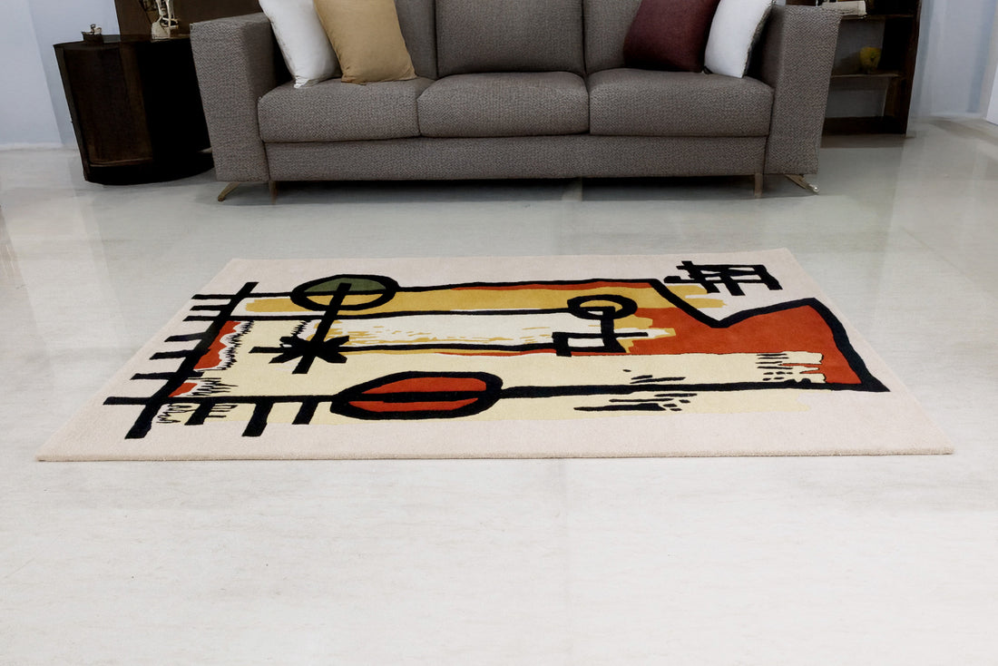 Abstract rug on a light-colored floor with a couch in the background