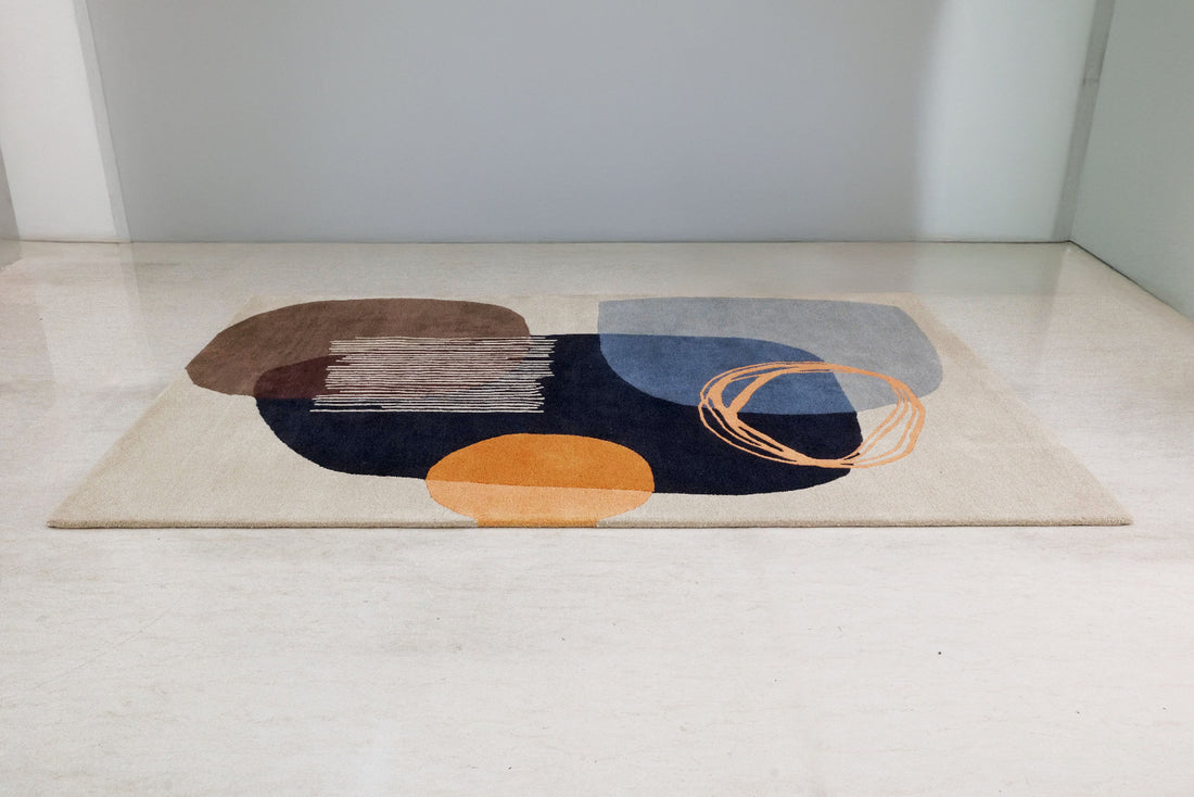 
                      
                        Abstract patterned rug on a light-colored floor
                      
                    