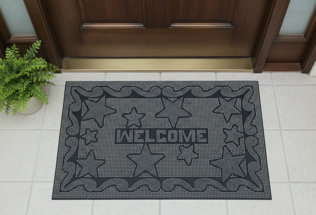 
                      
                        Black doormat with star patterns and 'WELCOME' text in front of a wooden door.
                      
                    