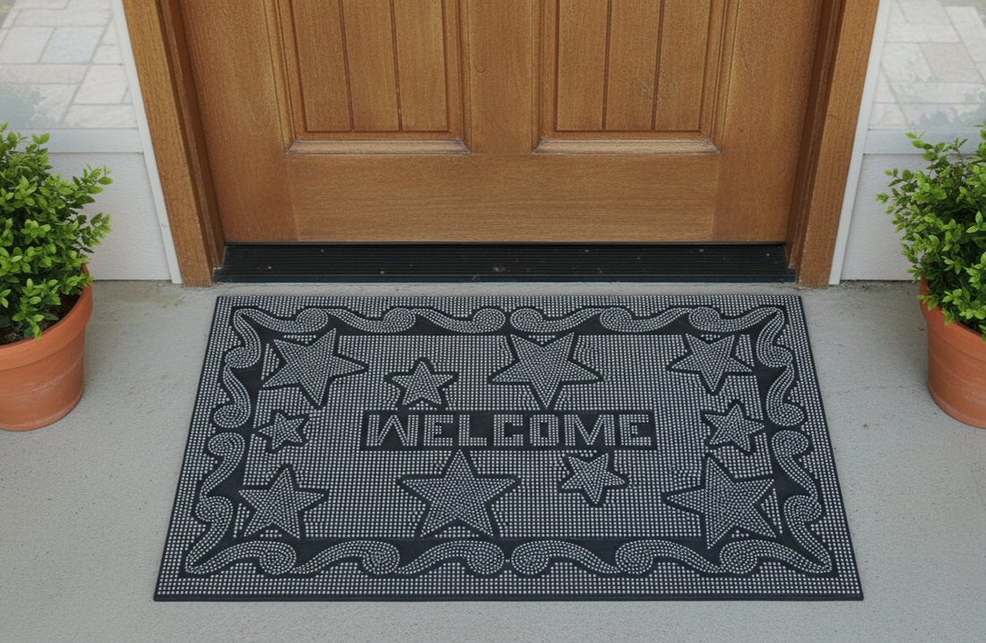 
                      
                        Black welcome mat with star patterns in front of a wooden door.
                      
                    