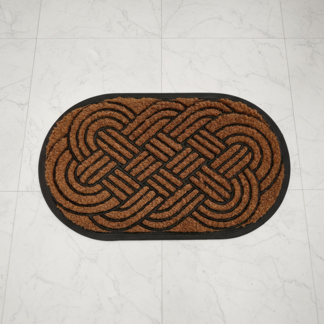 Brown doormat with a woven pattern on a white tiled floor