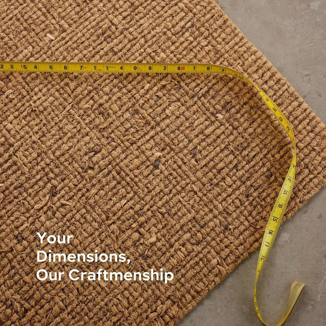 Brown textured coir mat with a measuring tape on a concrete floor, featuring the text 'Your Dimensions, Our Craftmanship'.