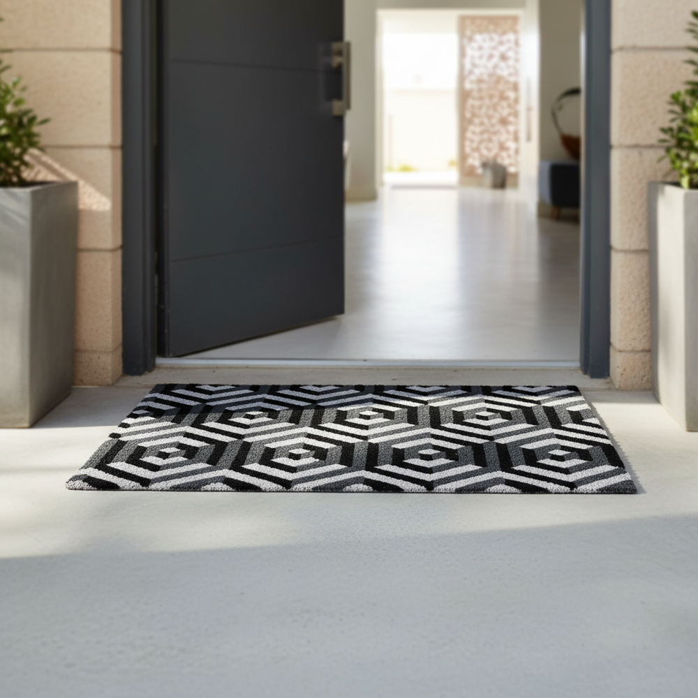 Black and white geometric patterned rug on a light gray floor in front of an open door.