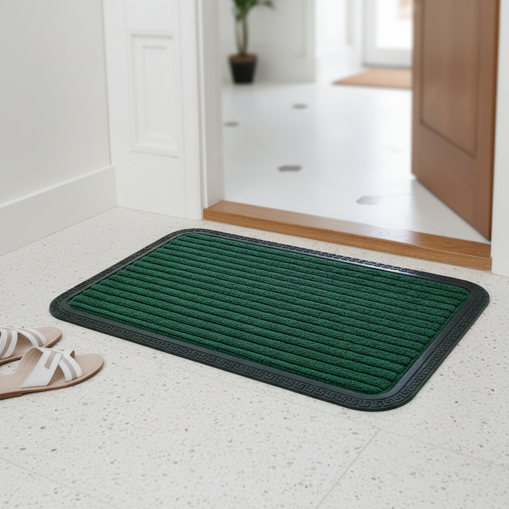 Green doormat on a light-colored floor with a bathroom in the background