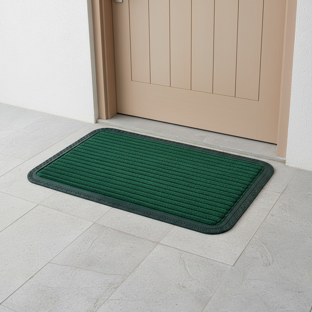 
                      
                        Green doormat on a tiled floor in front of a wooden door.
                      
                    