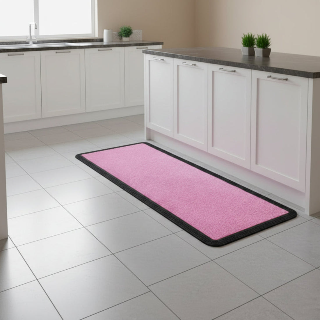 Pink kitchen mat on a tiled floor with white cabinets in the background