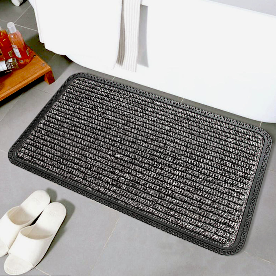 A grey striped Onlymat anti-slip doormat is placed on the floor outside, next to a pair of shoes, presumably to keep the area clean from dirt and mud.