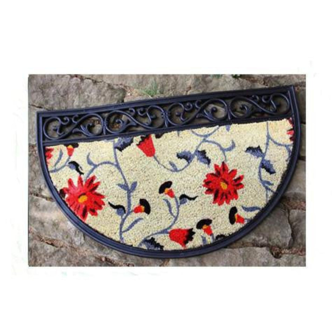 An oval-shaped, floral-patterned doormat with a black border, made from coconut fibre, placed on a stone surface.