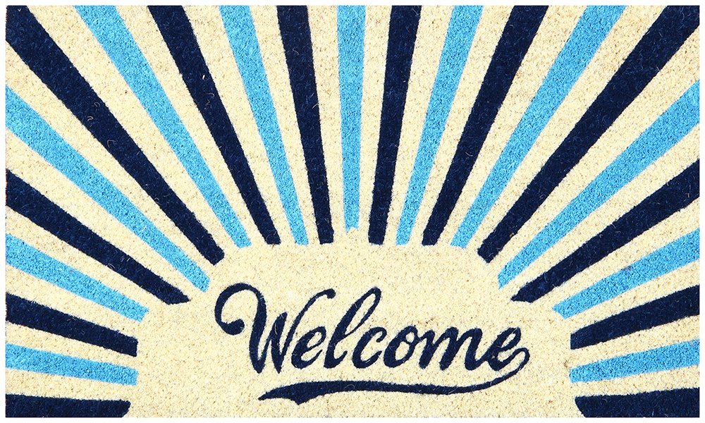 A rectangular coir doormat with a blue background and a retro design, featuring the text 'Welcome' in a bold, white font with a sunburst pattern behind it.