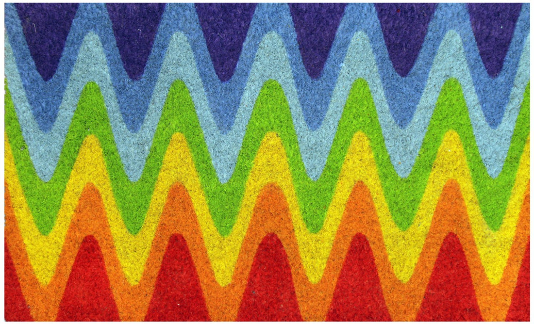 A multicoloured geometric patterned coir floor mat with a wave design, featuring angles and colours similar to a rainbow.