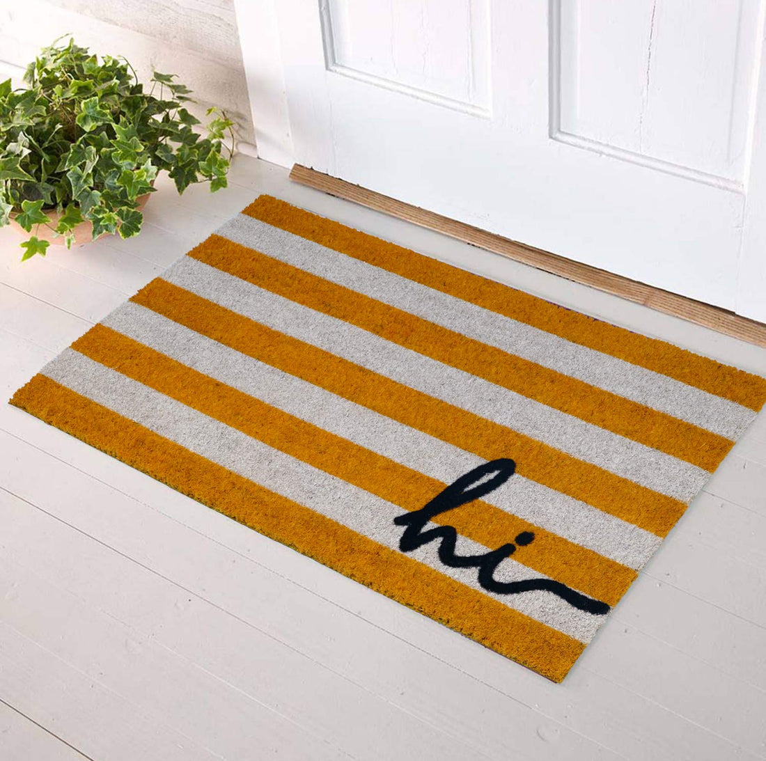 A colourful striped doormat with natural coir texture and the word 'hi' printed in black, placed on a white doorstep.