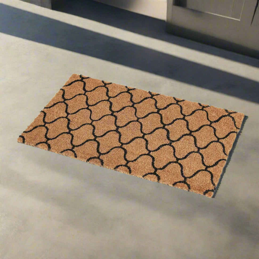 
                      
                        Patterned coir doormat on a concrete floor
                      
                    