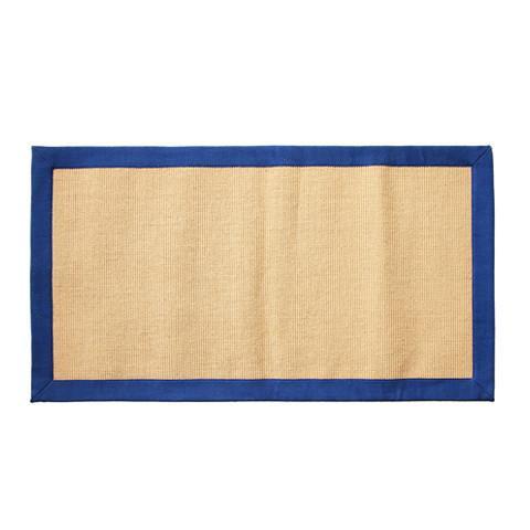 A rectangular jute floor mat with a blue cotton border.
