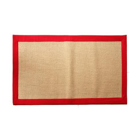 
                      
                        A rectangular jute floor mat with a red cotton border.
                      
                    