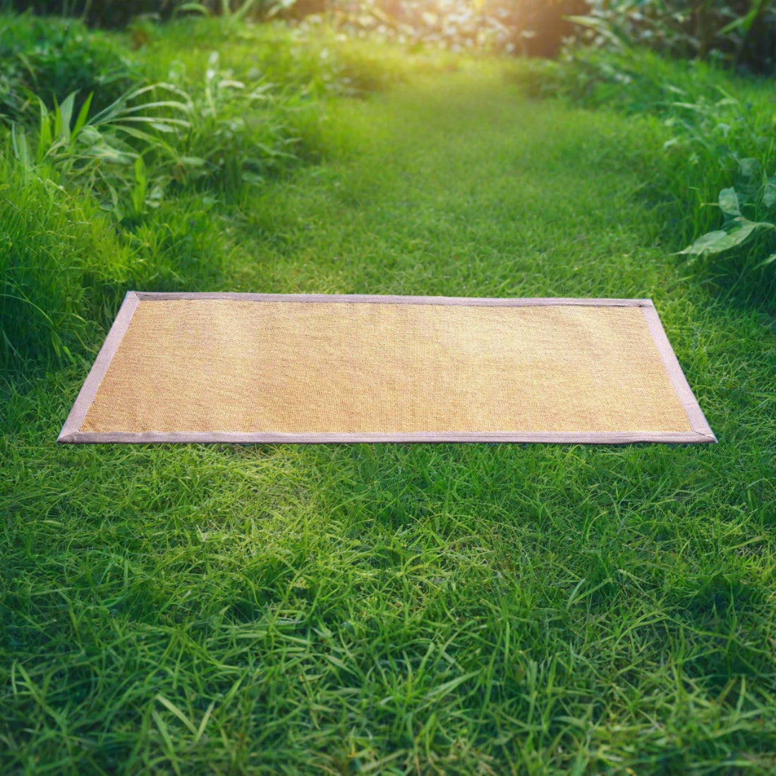 
                      
                        A beige jute yoga mat with a cotton border is placed on a grassy surface, displaying its features naturally.
                      
                    