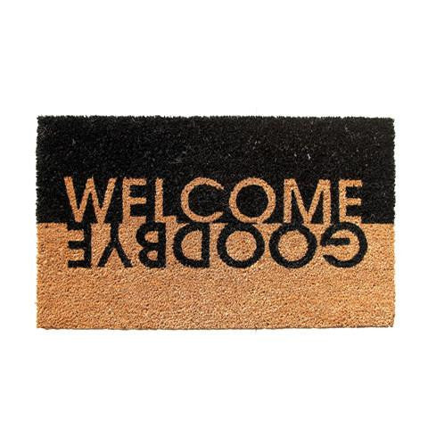 A rectangular natural coir door mat with black and brown colouring and the text 'Welcome Goodbye' printed on it.