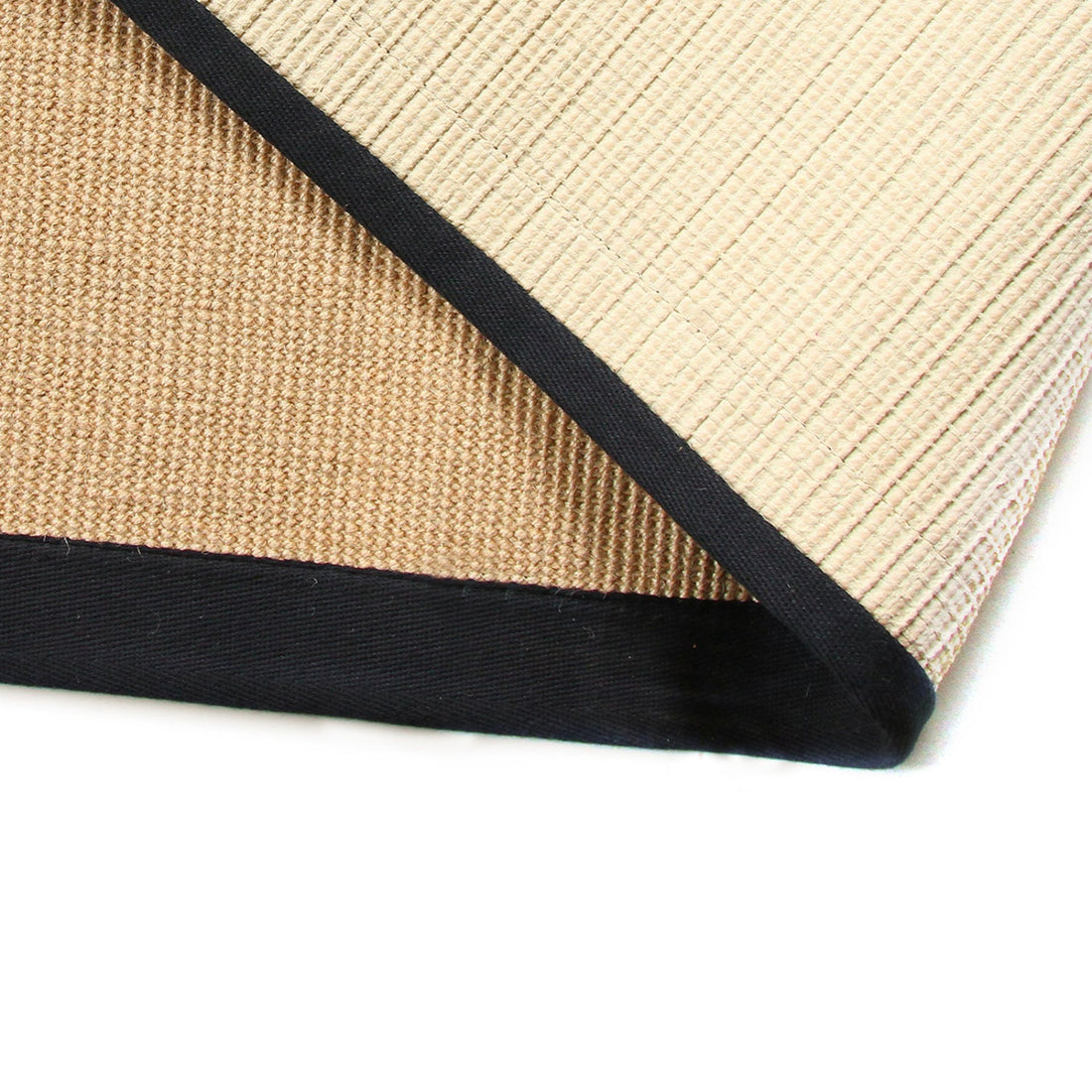 Close-up of a beige rug with a black border on a white background